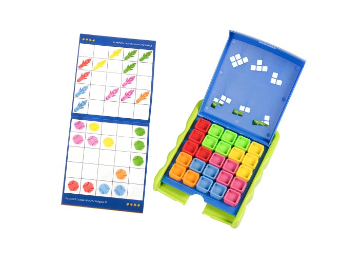 A children's toy set shown on a white background, featuring a blue and green plastic sorting tray with colorful numbered compartments and a matching instruction card with illustrated shapes and grids.